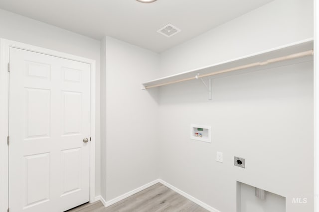 laundry area with light wood finished floors, visible vents, laundry area, hookup for a washing machine, and hookup for an electric dryer