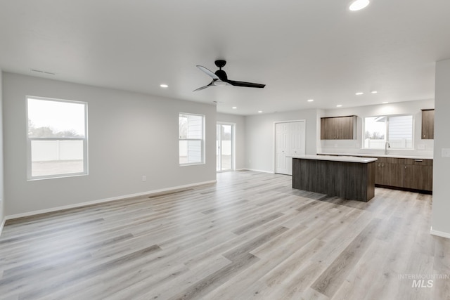 unfurnished living room with recessed lighting, plenty of natural light, and light wood-style flooring