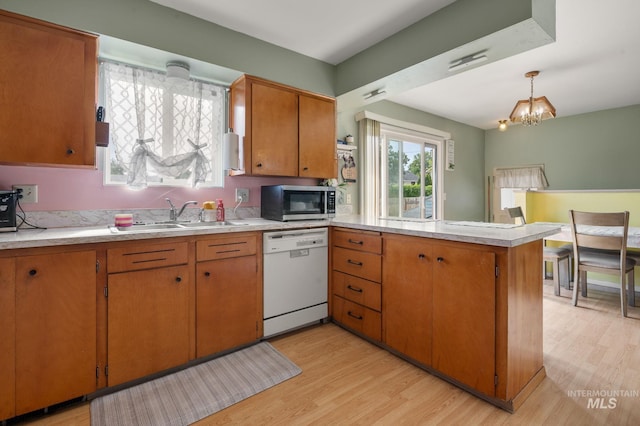 1713 12th St, Lewiston, ID 83501 - kitchen with dishwasher, a sink, stainless steel microwave, a peninsula, and light countertops