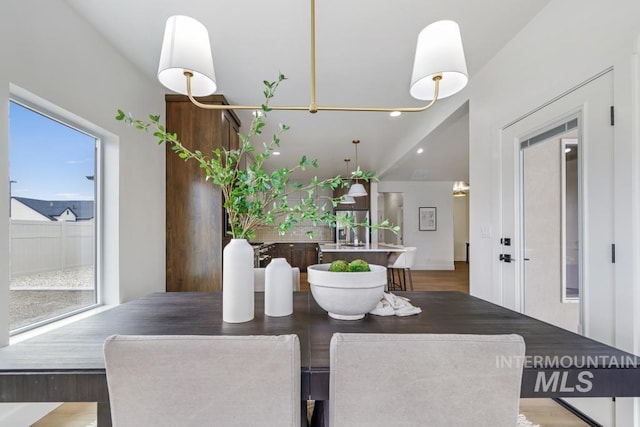 2215 Kooskia Loop, Twin Falls, ID 83301 - dining area featuring wood finished floors, healthy amount of natural light, recessed lighting, and lofted ceiling