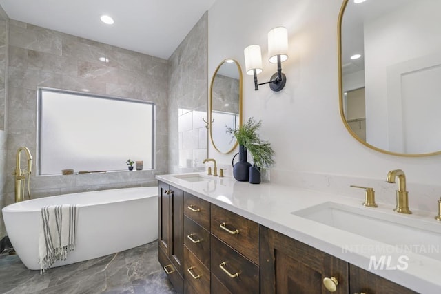 2215 Kooskia Loop, Twin Falls, ID 83301 - bathroom featuring marble tiled flooring, a freestanding bath, double vanity, recessed lighting, and tile walls