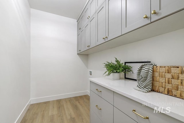2215 Kooskia Loop, Twin Falls, ID 83301 - laundry room with cabinet space, light wood-style floors, and hookup for a washing machine