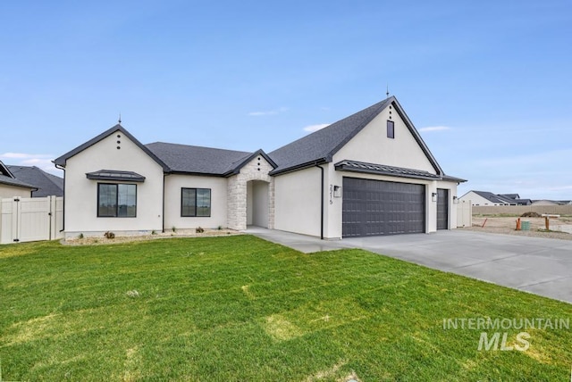 2215 Kooskia Loop, Twin Falls, ID 83301 - french country home with concrete driveway, stucco siding, a garage, a standing seam roof, and a gate