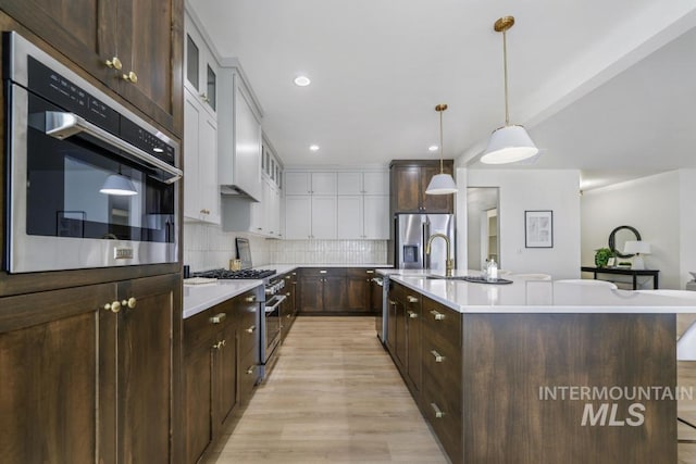 2215 Kooskia Loop, Twin Falls, ID 83301 - kitchen with appliances with stainless steel finishes, light countertops, dark brown cabinets, white cabinetry, and recessed lighting
