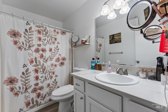 3004 Sandstone Pl, Caldwell, ID 83605 - full bathroom with toilet, wood finished floors, vanity, and a shower with curtain