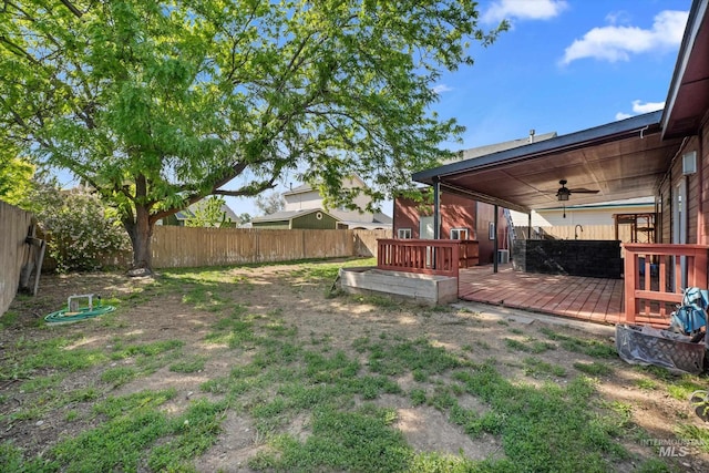 3004 Sandstone Pl, Caldwell, ID 83605 - fenced backyard featuring a wooden deck and a ceiling fan
