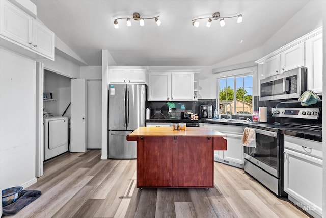 3004 Sandstone Pl, Caldwell, ID 83605 - kitchen featuring stainless steel appliances, lofted ceiling, a sink, butcher block counters, and decorative backsplash