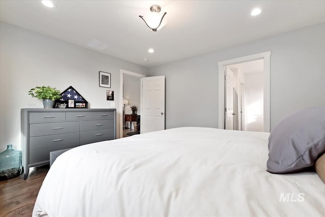 bedroom with dark wood-style flooring and recessed lighting