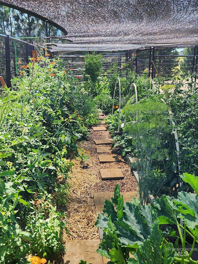 exterior space with a vegetable garden and fence