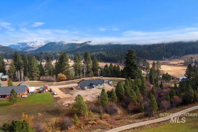 birds eye view of property with a mountain view and a wooded view