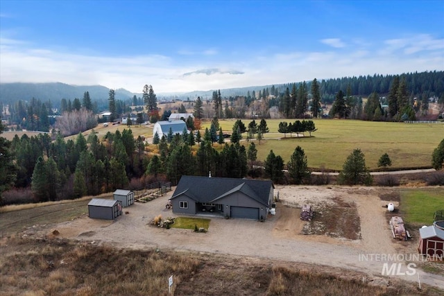 drone / aerial view with a view of trees and a rural view