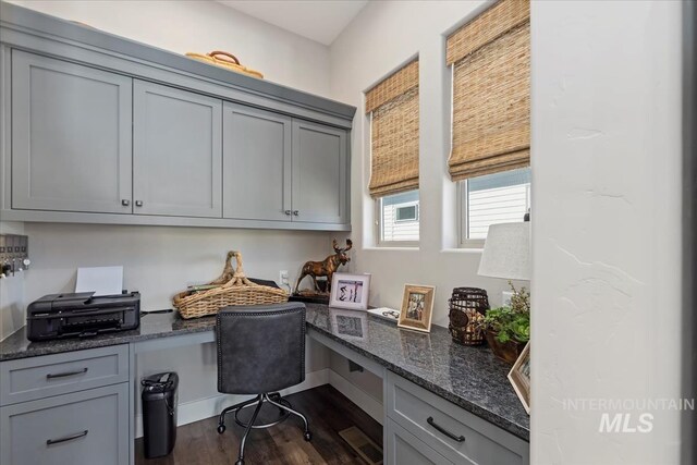 home office featuring built in desk and dark wood-type flooring