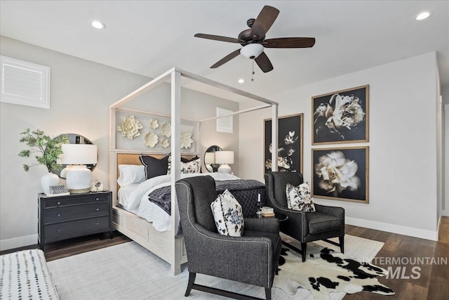 bedroom with ceiling fan and dark hardwood / wood-style flooring