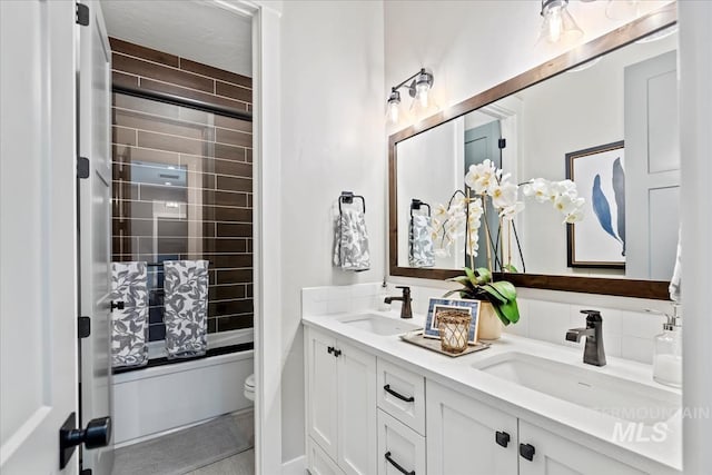 full bathroom with toilet, tiled shower / bath, and vanity