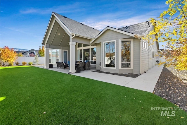 back of property featuring a lawn and a patio