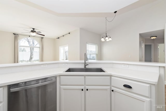 kitchen featuring ceiling fan with notable chandelier, white cabinetry, sink, vaulted ceiling, and stainless steel dishwasher