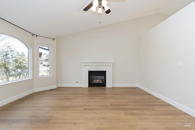 unfurnished living room featuring ceiling fan, a fireplace, and light hardwood / wood-style flooring