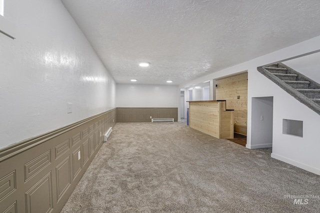 201 E 27th St, Burley, ID 83318 - finished below grade area featuring bar area, carpet, a baseboard heating unit, and a textured ceiling
