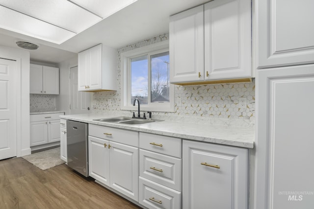 201 E 27th St, Burley, ID 83318 - kitchen with tasteful backsplash, white cabinetry, light wood-style floors, stainless steel dishwasher, and a sink