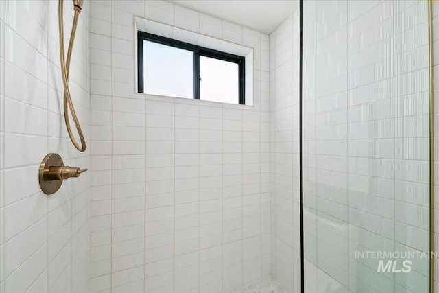 bathroom with a tile shower