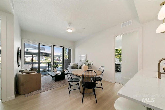 dining room with light hardwood / wood-style floors and sink