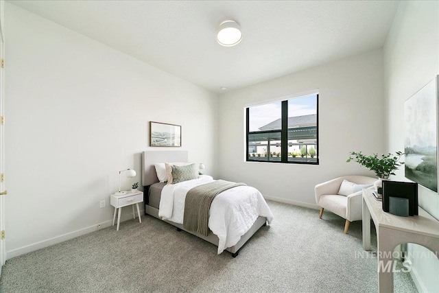 bedroom with light colored carpet