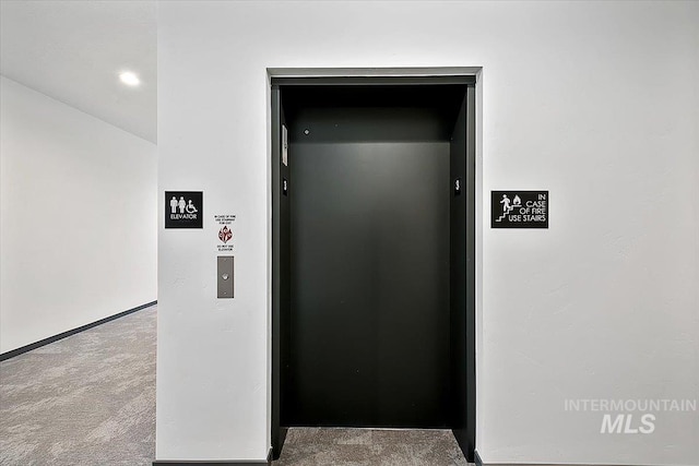 interior details featuring carpet flooring and elevator