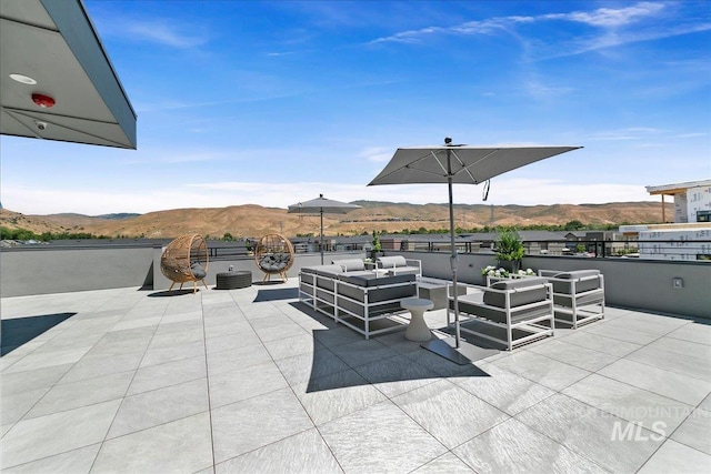 view of patio / terrace featuring a mountain view and an outdoor hangout area