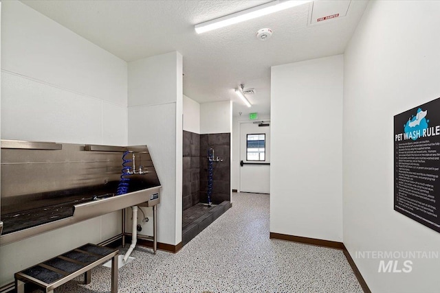 miscellaneous room featuring a textured ceiling