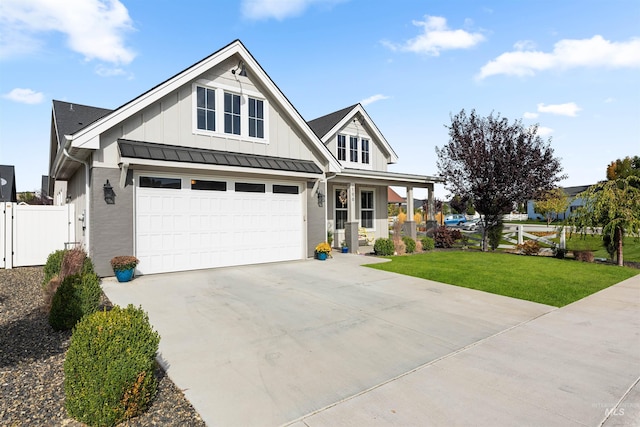 craftsman house with board and batten siding, a garage, fence, a front lawn, and concrete driveway