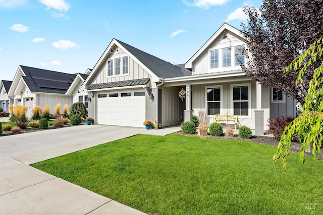 view of front of home with board and batten siding, covered porch, a standing seam roof, a front lawn, and concrete driveway