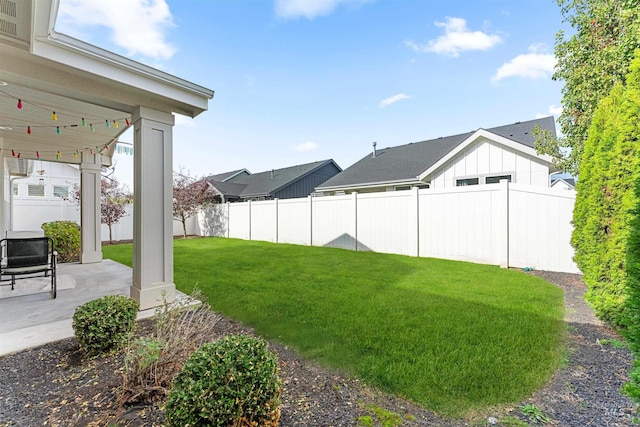 view of yard with fence and a patio