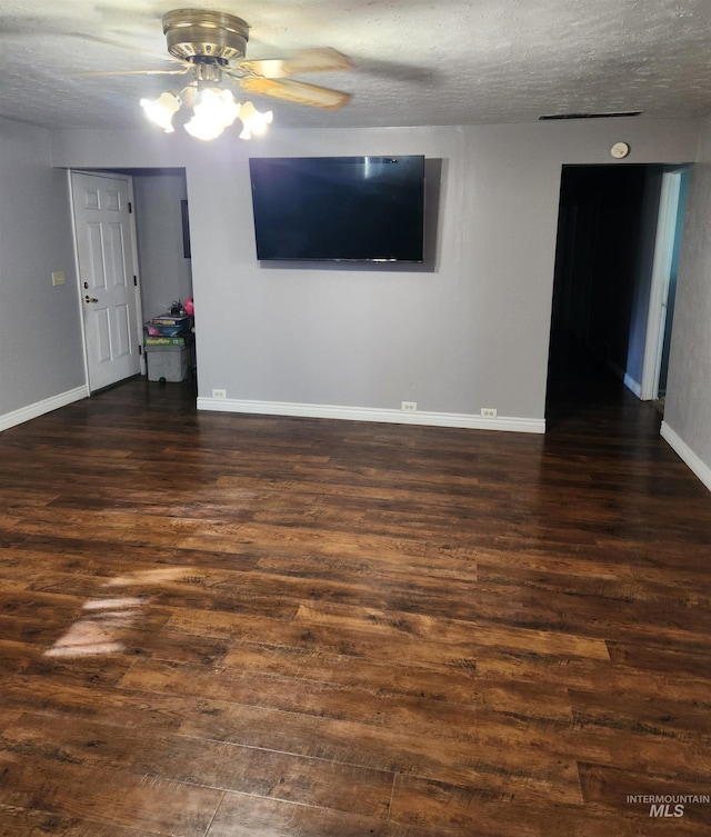 846 Wyoming St, Gooding, ID 83330 - empty room with baseboards, a ceiling fan, a textured ceiling, and dark wood-style flooring