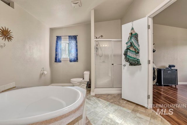 bathroom featuring shower with separate bathtub, lofted ceiling, toilet, and tile patterned flooring