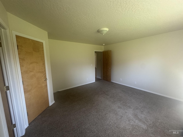 2451 W Park Stone Dr, Meridian, ID 83646 - unfurnished room featuring dark colored carpet, a textured ceiling, and baseboards
