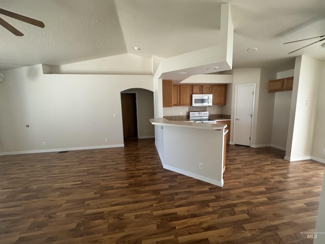 2451 W Park Stone Dr, Meridian, ID 83646 - kitchen with white appliances, ceiling fan, brown cabinets, arched walkways, and a textured ceiling