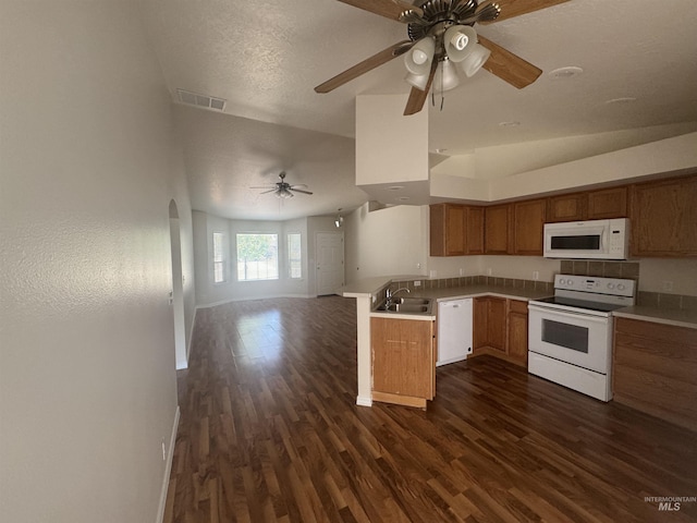 2451 W Park Stone Dr, Meridian, ID 83646 - kitchen featuring white appliances, open floor plan, dark wood-style flooring, a ceiling fan, and a peninsula