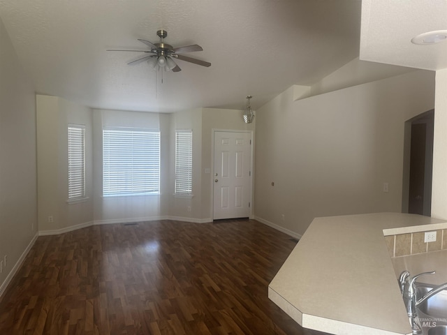 2451 W Park Stone Dr, Meridian, ID 83646 - unfurnished living room featuring dark wood-type flooring, ceiling fan, and baseboards