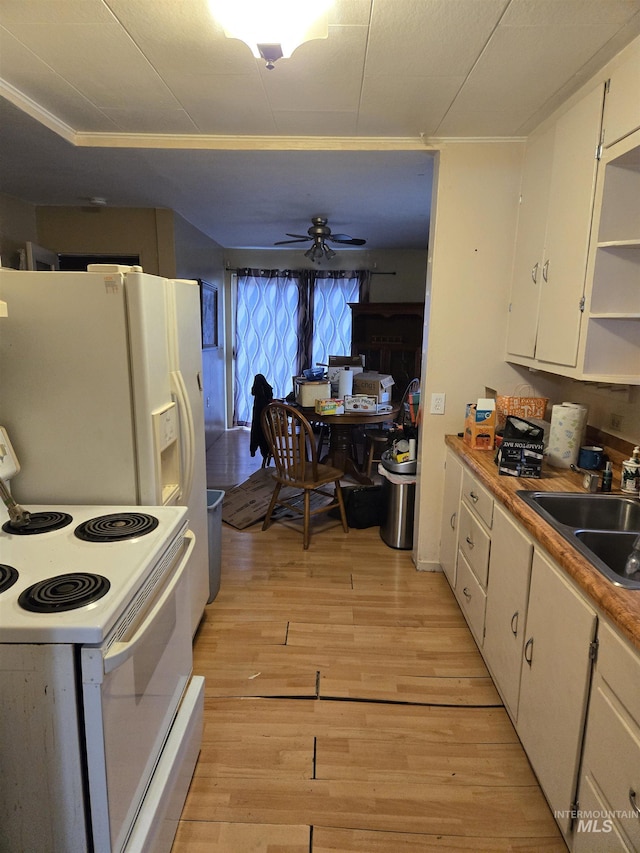 kitchen featuring sink, white appliances, white cabinets, and light wood-type flooring