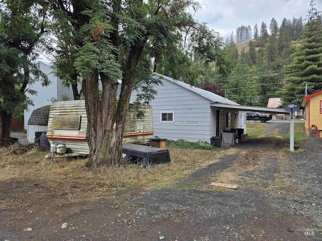 view of side of property featuring a carport