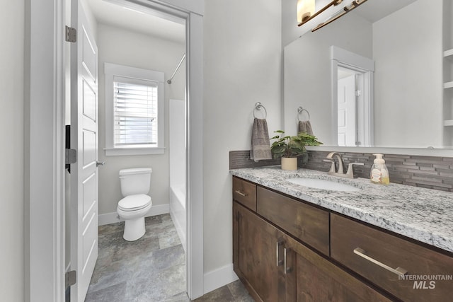 full bathroom with toilet, washtub / shower combination, baseboards, and vanity