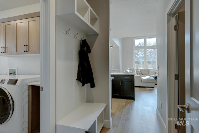 mudroom with washer / dryer and light wood-type flooring