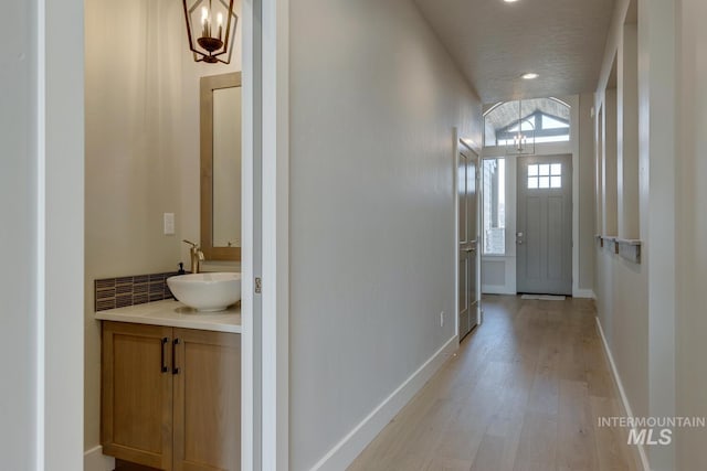 entryway with sink and light hardwood / wood-style floors