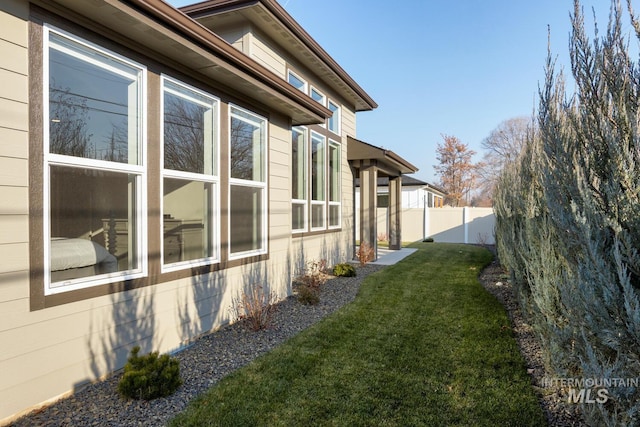 view of property exterior featuring a lawn