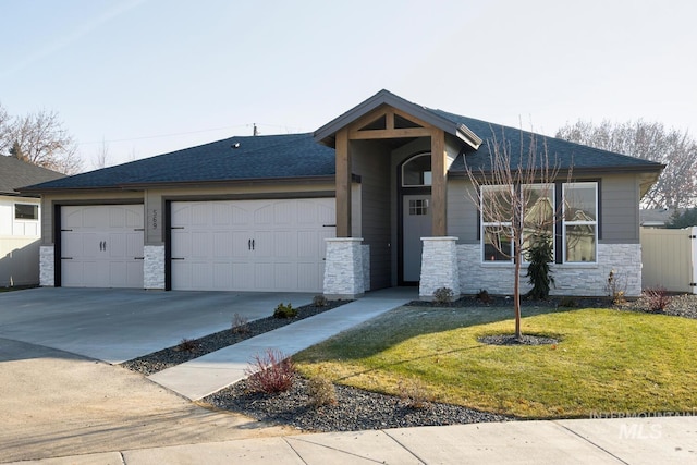 view of front of house with a garage and a front lawn