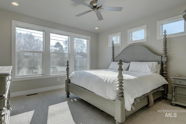 bedroom with ceiling fan and light carpet