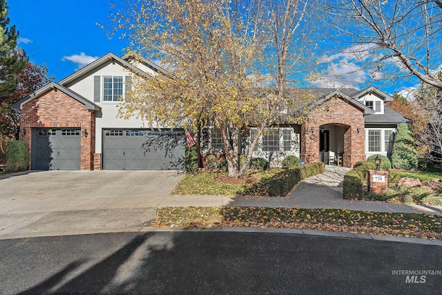 724 E Lakebrook Ln, Eagle, ID 83616 - traditional-style home with brick siding, concrete driveway, a garage, and stucco siding