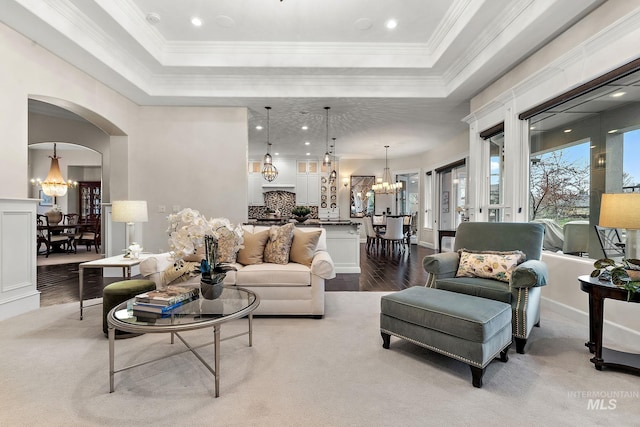 724 E Lakebrook Ln, Eagle, ID 83616 - living area with a chandelier, a raised ceiling, dark wood-type flooring, crown molding, and arched walkways