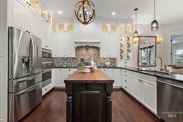 724 E Lakebrook Ln, Eagle, ID 83616 - kitchen with stainless steel appliances, butcher block countertops, dark wood-type flooring, backsplash, and decorative light fixtures