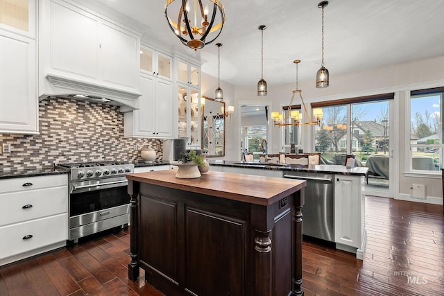 724 E Lakebrook Ln, Eagle, ID 83616 - kitchen with butcher block countertops, a chandelier, appliances with stainless steel finishes, a center island, and dark wood-style flooring